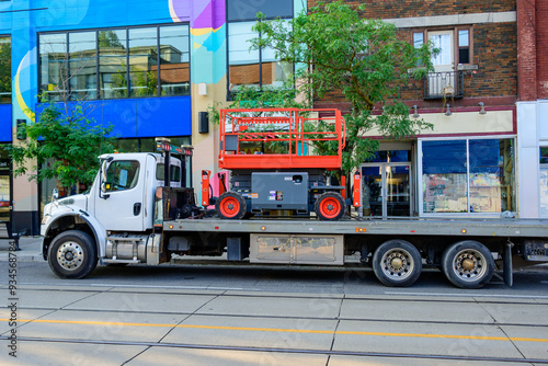 Canvas Print Scissor Lift (mobile platform lift) on a tilt and load flatbed truck parked on a