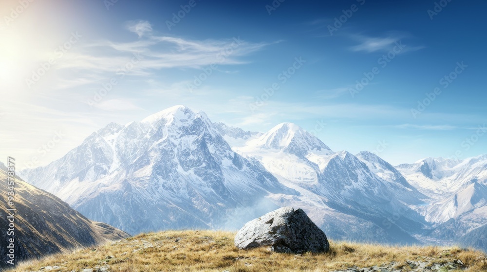 Fototapeta premium Majestic mountain range with snow-capped peaks and clear blue sky above. Majestic Mountain Range