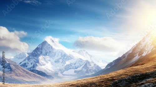 Majestic mountain range with snow-capped peaks and clear blue sky above. Majestic Mountain Range