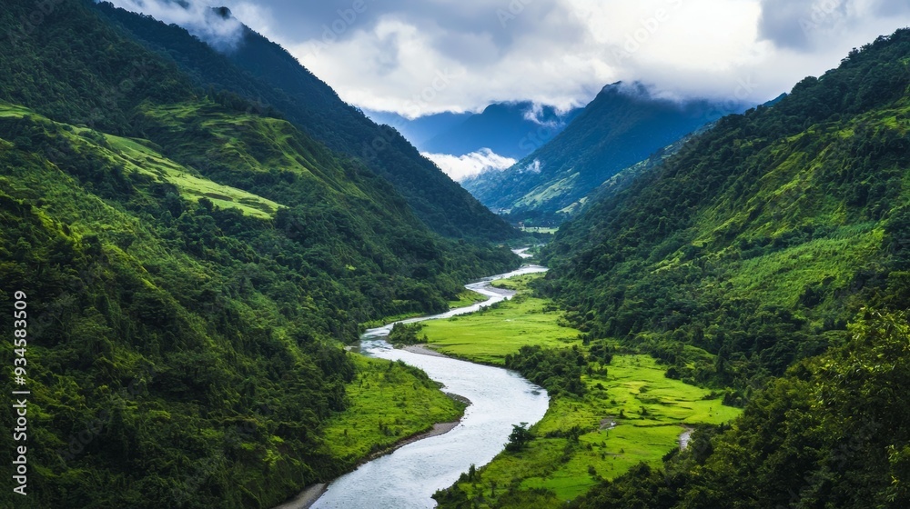 Naklejka premium A peaceful valley surrounded by lush green mountains and gentle river flowing through it. Serene Mountain Valley