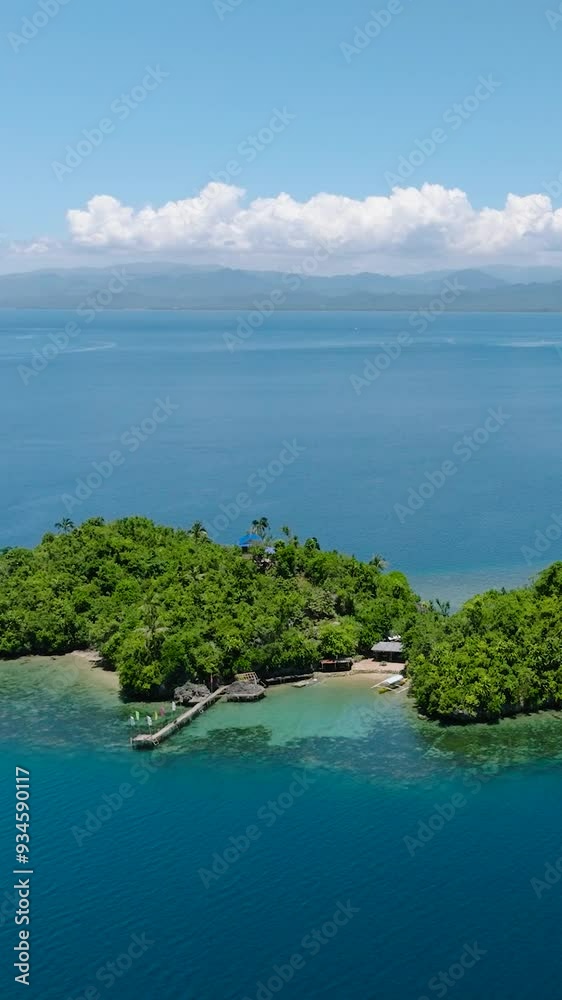Islands with beach resort in tropical landscape. Bangkay Island. Mindanao, Philippines. Vertical view. Islands with beach resort in tropical landscape. Bangkay Island. Mindanao, Philippines. Vertical view.