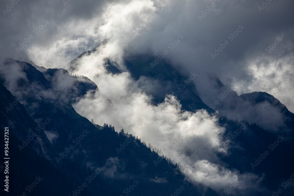 USA, Alaska, Tracy Arm-Fords Terror Wilderness, Morning sun lights mist swirling in mountains above Holkham Bay USA, Alaska, Tracy Arm-Fords Terror Wilderness, Morning sun lights mist swirling in mountains above Holkham Bay