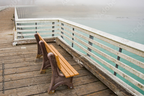 USA, California. San Simeon, empty bench on wharf.