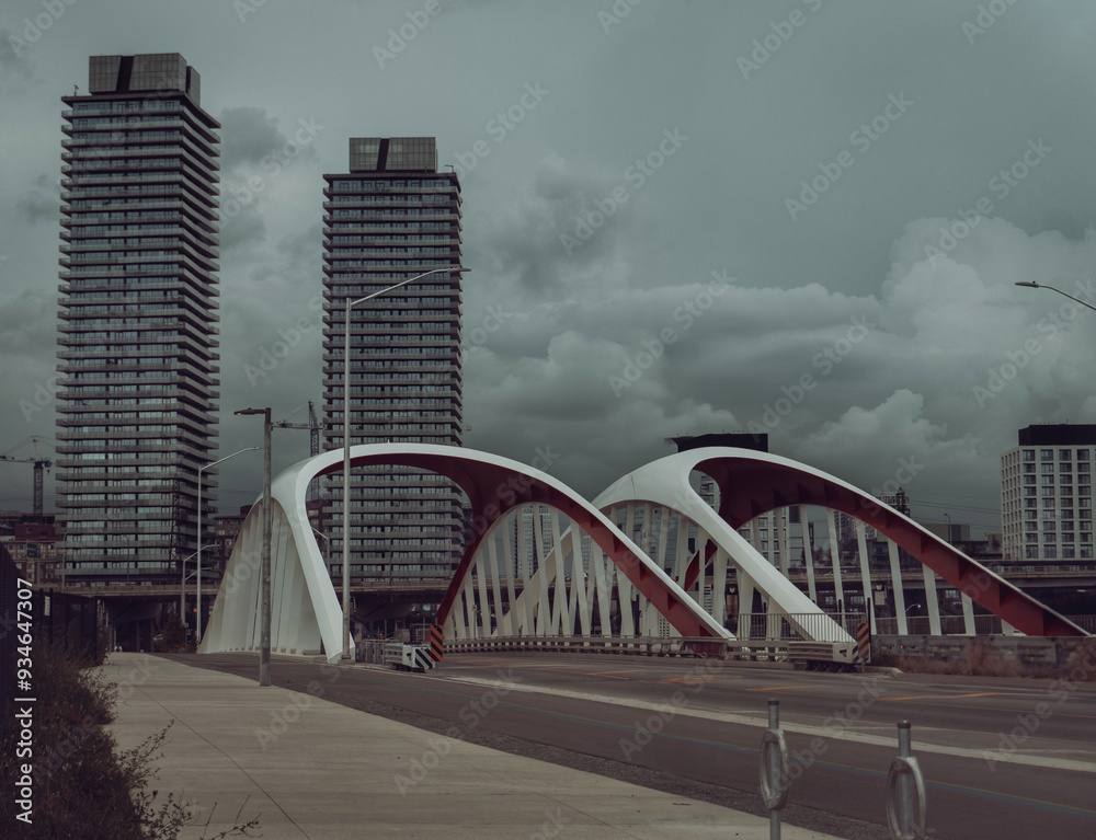 Fototapeta premium road with a bridge and futuristic buildings and gloomy sky before the rain