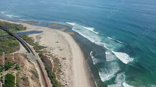 Aerial view of surfers riding waves at Trestles beach in Southern California