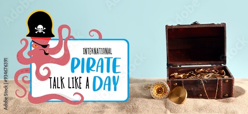 Bilde på lerret Old chest with treasure and compass on sand against light blue background