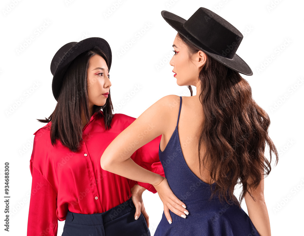 Beautiful young Asian women in stylish outfits on white background