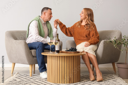 Mature couple with bottle a...