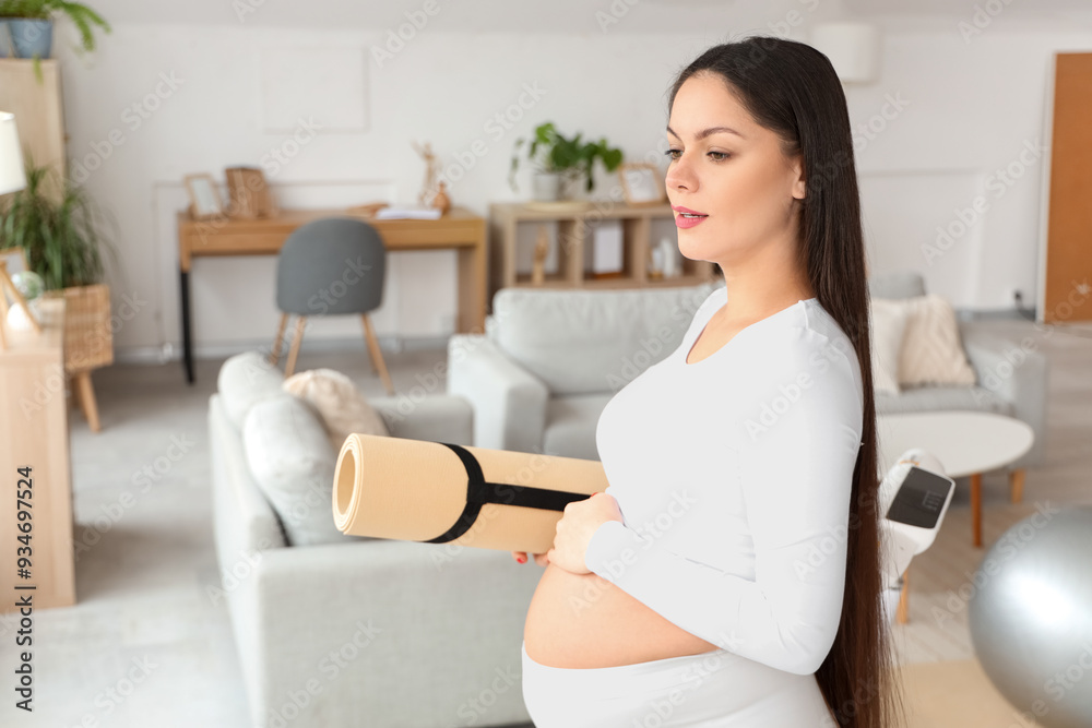 Sporty pregnant woman with fitness mat at home Sporty pregnant woman with fitness mat at home
