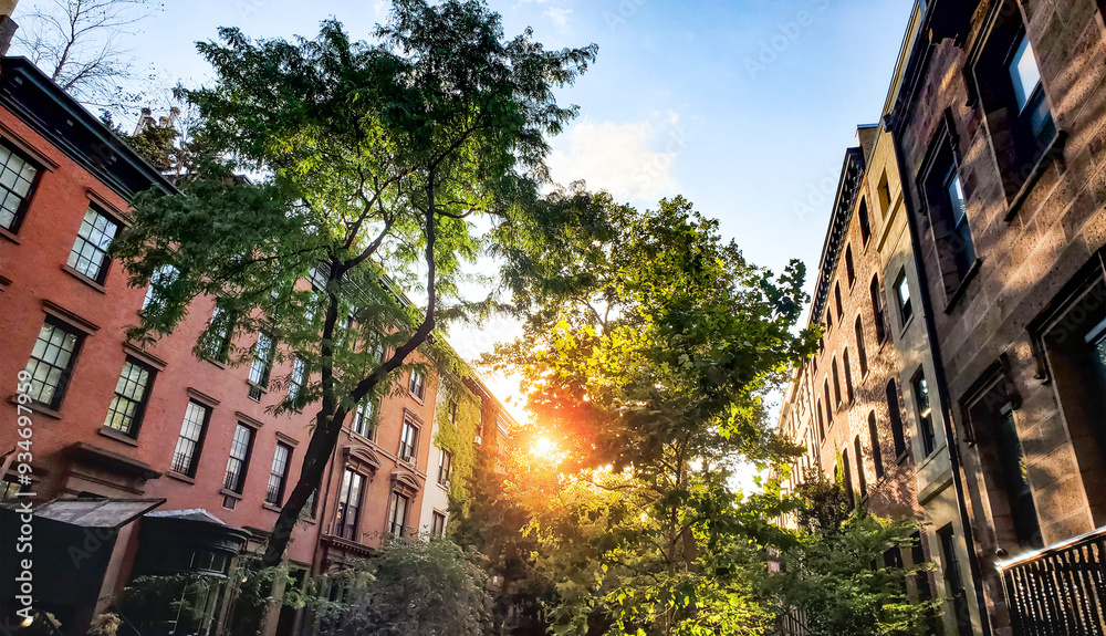 Tree lined block of historic apartment buildings on 10th Street in the Greenwich Village neighborhood of New York City