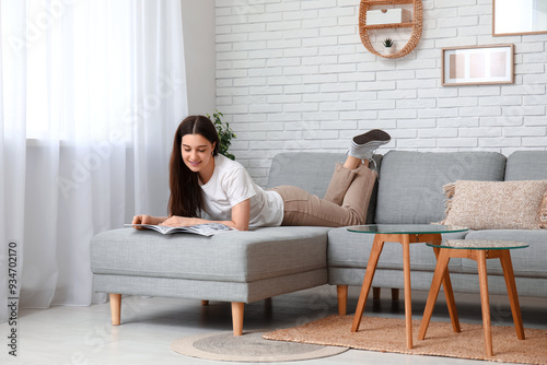 Young woman lying and readi...