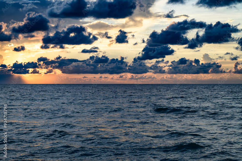 Obraz premium Seascape with dramatic sky and colorful clouds. Sky over sea water landscape. Stormy dramatic sky. Scenic seascape at sea.