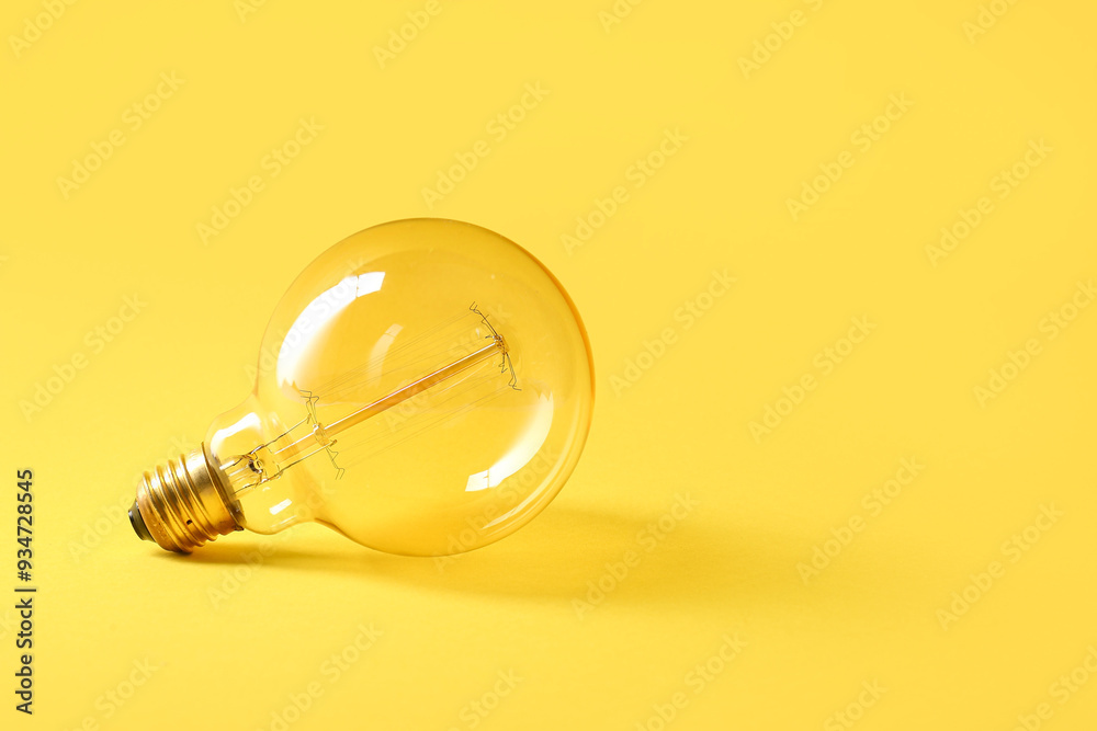 Round retro light bulb on yellow background