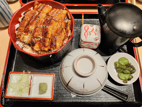 Hitsumabushi is a Japanese Nagoya rice dish decorated with grilled Unagi eel at the top. photo