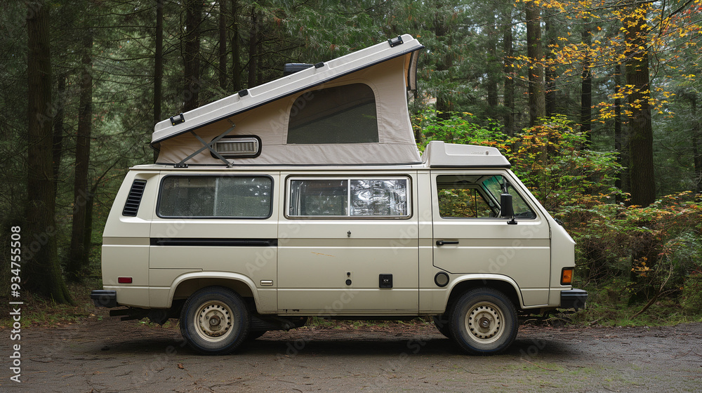 A white camper van with a pop-up top parked in a forest
A white camper van with a pop-up top parked in a forest