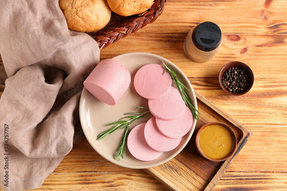 Plate with slices of tasty boiled sausage, bread and mustard sauce on brown wooden background Plate with slices of tasty boiled sausage, bread and mustard sauce on brown wooden background