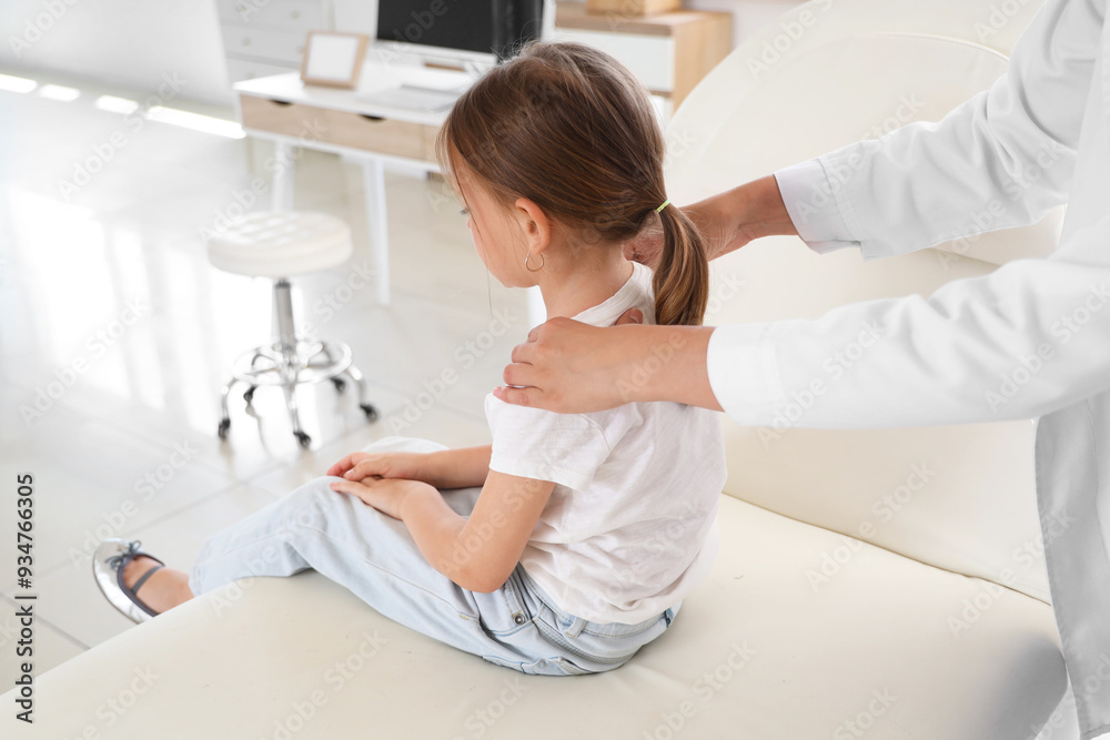 Female osteopath working with little patient in clinic Female osteopath working with little patient in clinic