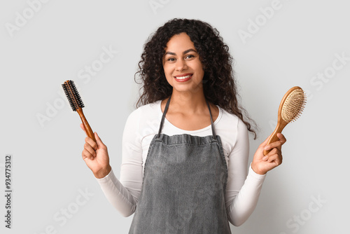 Smiling female hairdresser ...