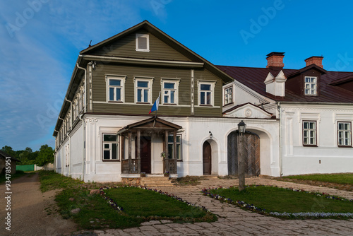 View of historical merchant buildings of estates on the main street of Izborsk Pechorskaya Street on a summer sunny day, Izborsk, Pskov region, Russia