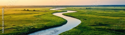 Winding River Through Lush Green Fields.