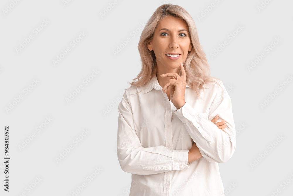 Thoughtful mature businesswoman on light background Thoughtful mature businesswoman on light background