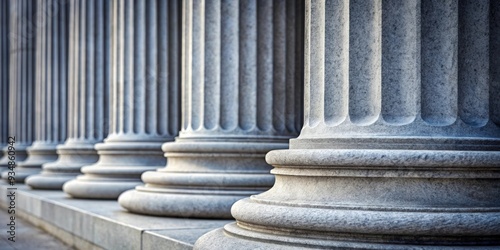 Close up of grey stone pillars symbolizing law and justice with space for copy text in the background