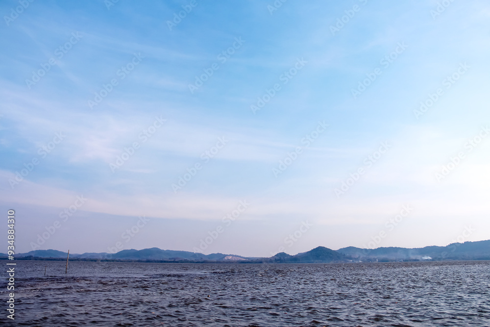 Blue sky clouds background over mountains view and seascape Blue sky clouds background over mountains view and seascape