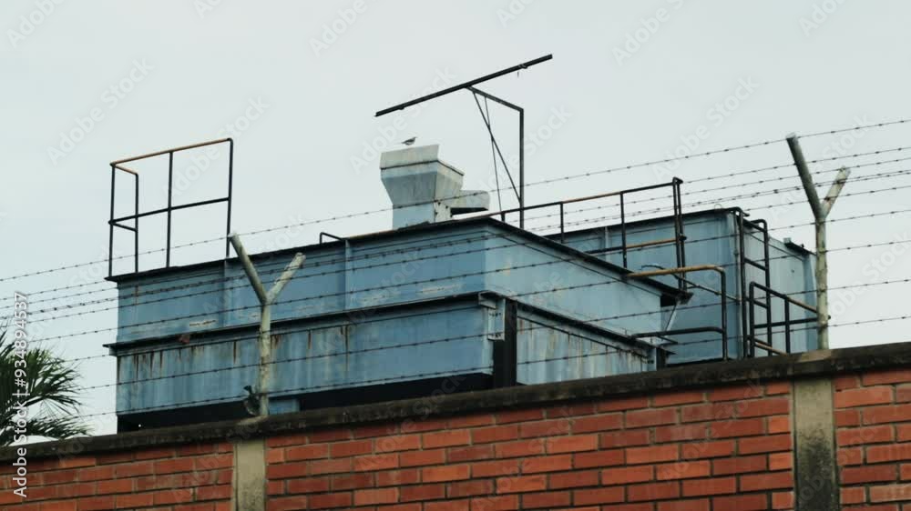 Blue factory behind a brick wall Blue factory behind a brick wall