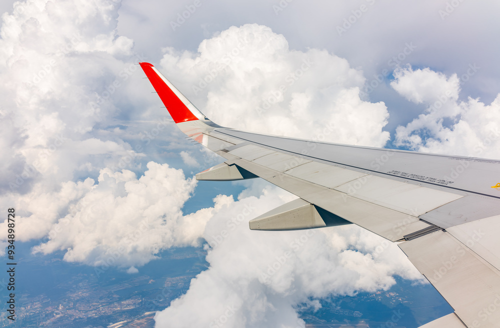 View from the airplane window at a beautiful cloudy sky and the airplane wing View from the airplane window at a beautiful cloudy sky and the airplane wing