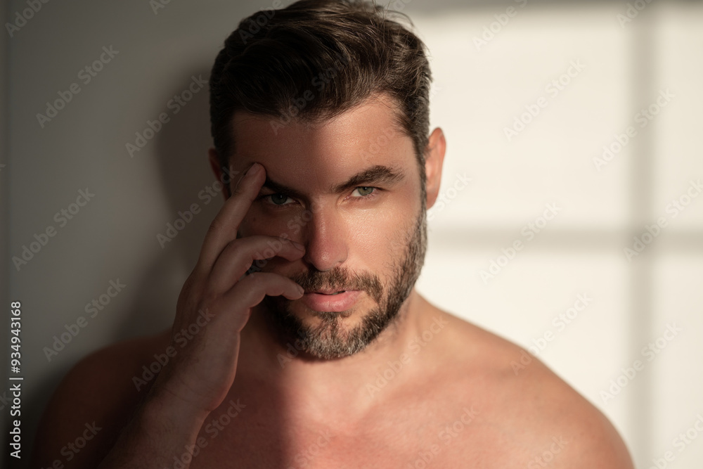 Obraz premium Close up portrait of half naked man 40s . Handsome serious middle aged man with fresh perfect smooth skin. Portrait of a beautiful man with perfect faces skin. Face care, male cosmetics.
