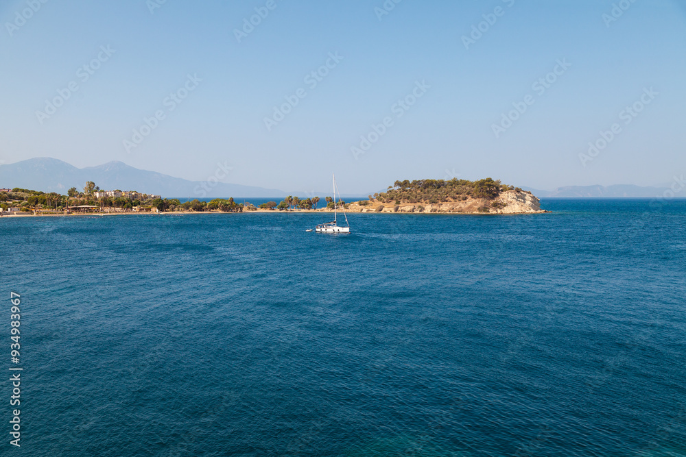 Small White Sailboat in a Coastal Bay - Aerial View Small White Sailboat in a Coastal Bay - Aerial View