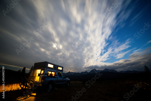 Nighttime Camping Under a Starry Sky with Dramatic Clouds