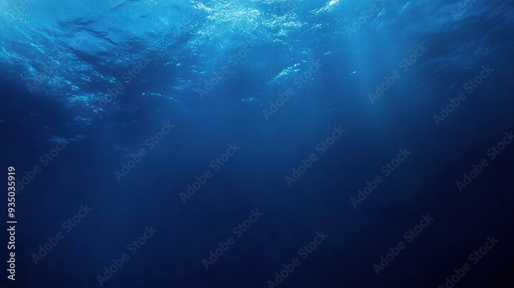 Deep Blue Abyss: Sunbeams pierce the surface of a deep blue ocean, illuminating the depths below. Deep Blue Abyss: Sunbeams pierce the surface of a deep blue ocean, illuminating the depths below.