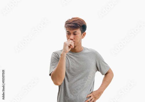 A young Asian man in his 20s wearing a gray t-shirt is looking suspicious and has a confused expression or is thinking, isolated on a gray background