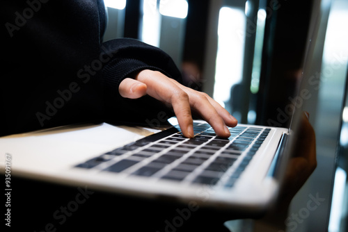 A laptop with a blank screen sits against a dark background, symbolizing the ominous nature of cyber threats. The image reflects themes of hacking, data breaches, and the importance of network securit photo