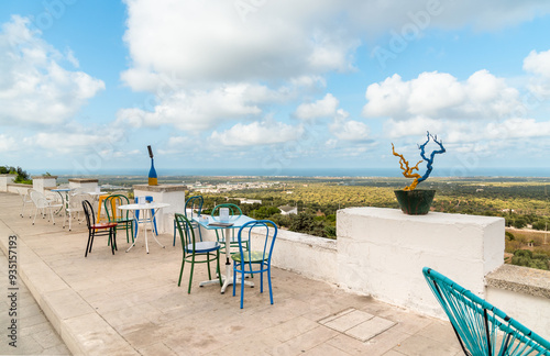 Fotografía Sidewalk cafe with panoramic view outside the white walls of the ancient city of