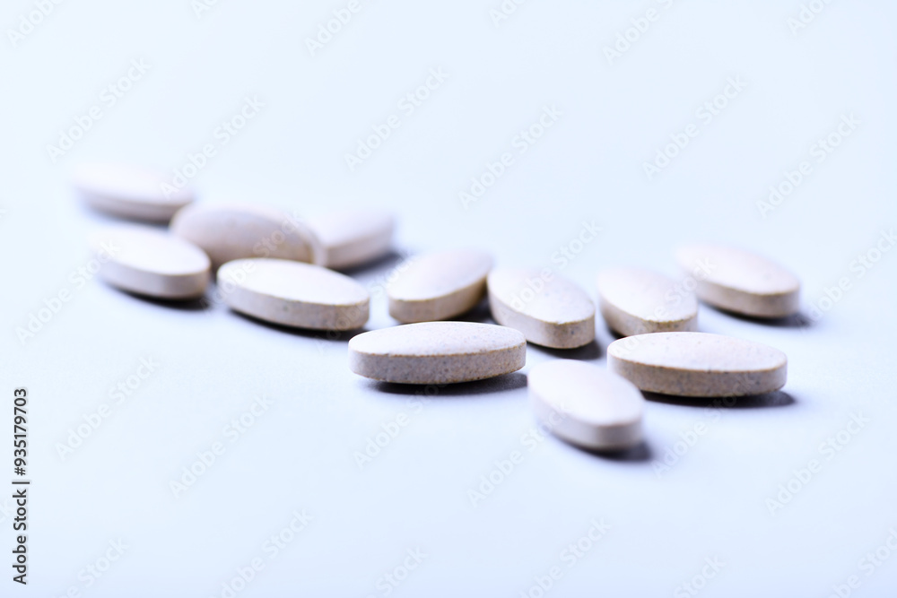 Ashwagandha (Withania somnifera) tablets. Concept for a healthy dietary supplementation. Bright paper background. Close up. Copy space. Ashwagandha (Withania somnifera) tablets. Concept for a healthy dietary supplementation. Bright paper background. Close up. Copy space.