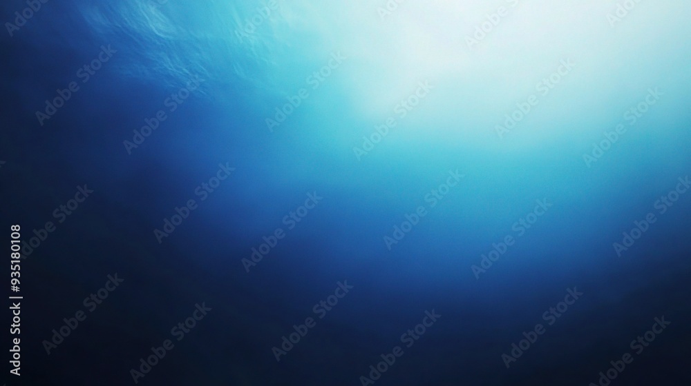 Deep Blue Abyss: Sunlight pierces the surface of a vast ocean, casting ethereal rays through the deep blue depths. 