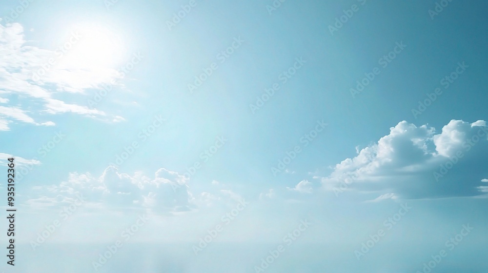 Obraz premium Serene Blue Sky: A tranquil expanse of azure sky, bathed in the soft glow of the sun, with wispy white clouds drifting gracefully across the horizon. 