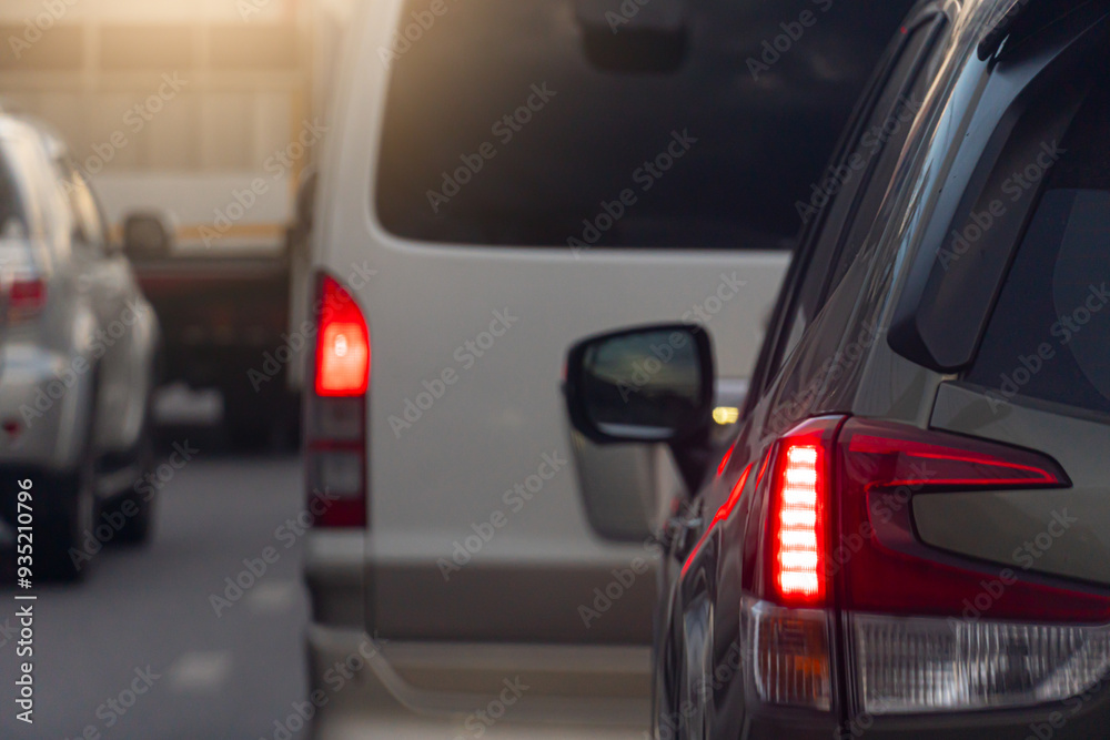 Rear side of car on the aspahlt road. Transtport of car turn on brake light in the business time environment of moring time. Traffic congestion and queues of cars. Rear side of car on the aspahlt road. Transtport of car turn on brake light in the business time environment of moring time. Traffic congestion and queues of cars.