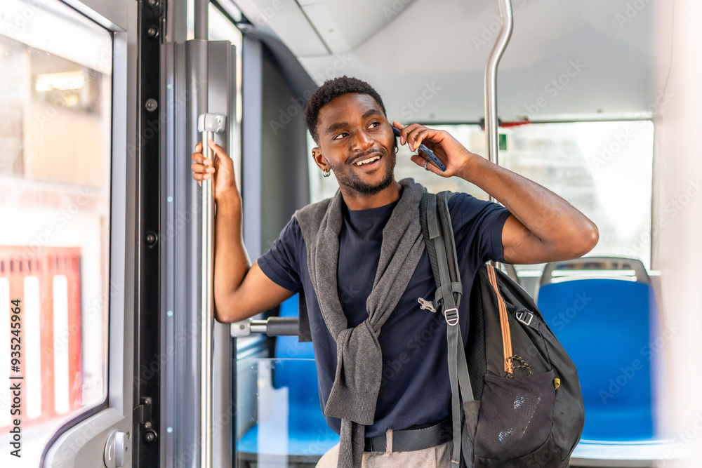African businessman talking to the cellphone standing on the bus African businessman talking to the cellphone standing on the bus