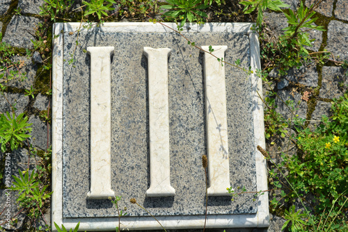 Building materials, memorials, beautiful, white inscriptions in gray and brown granite in the form of Roman numerals one, two, three, four, five, six, seven, eight, nine and ten. photo