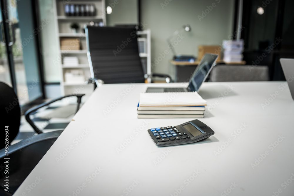 Fototapeta premium A modern office desk with a laptop, monitor, and plant. sleek, minimal design features open space, technology and productivity. room is empty, offering a clean and organized workspace.