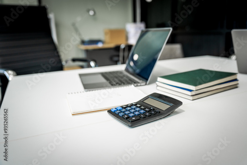 A modern office desk with a laptop, monitor, and plant. sleek, minimal design features open space, technology and productivity. room is empty, offering a clean and organized workspace.