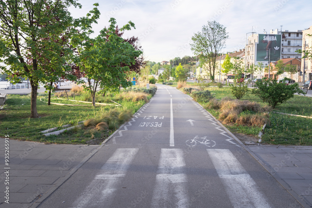 Fototapeta premium A road with a white line down the middle and a bike lane on the right