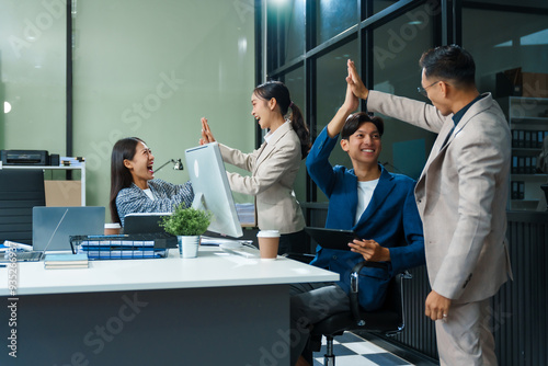 Asian colleagues meet at a desk, discussing business financial terms, investment strategies, managing funds. Their focus is on planning, analysis, and operations to ensure stability and success.