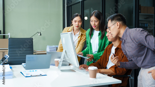 In a boardroom, an Asian team discusses startup financials and business terms. They present strategies on acquisitions, cash flow, and investor relations, innovative approaches for company growth. photo