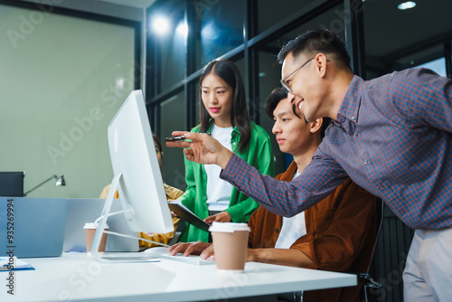 In a boardroom, an Asian team discusses startup financials and business terms. They present strategies on acquisitions, cash flow, and investor relations, innovative approaches for company growth.