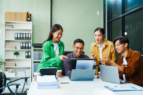 In a boardroom, an Asian team discusses startup financials and business terms. They present strategies on acquisitions, cash flow, and investor relations, innovative approaches for company growth. photo