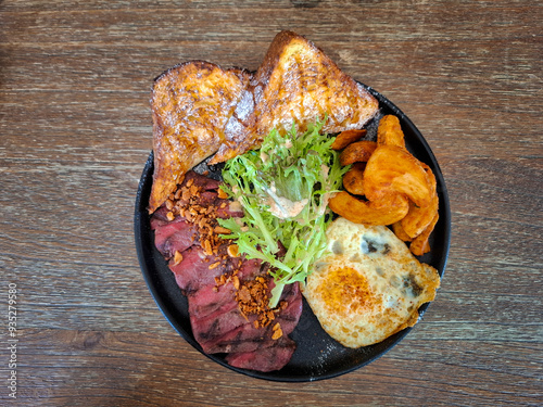 Brunch with red meat, egg, potato, bread and salad photo